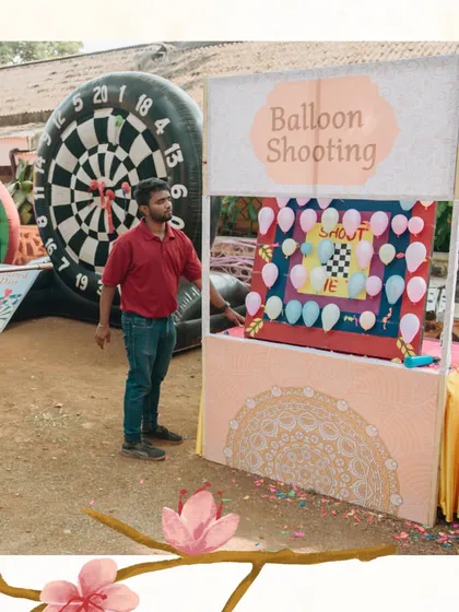 A full view of the balloon shooting and dartboard stalls we set up for a wedding carnival. These interactive games are always a huge hit with guests.