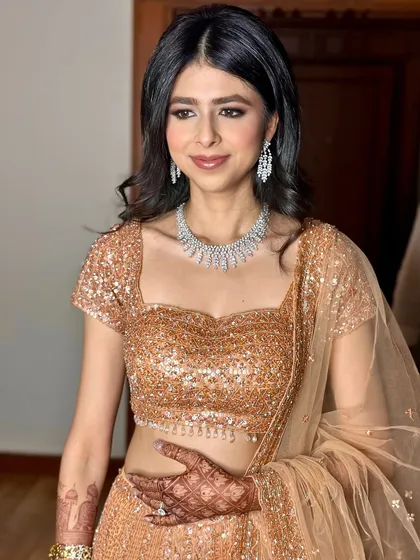A portrait showcasing the complete reception look. The diamond necklace and soft makeup create a look of understated luxury.