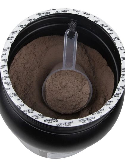 A top-down view of an open tub of rich chocolate whey protein powder.