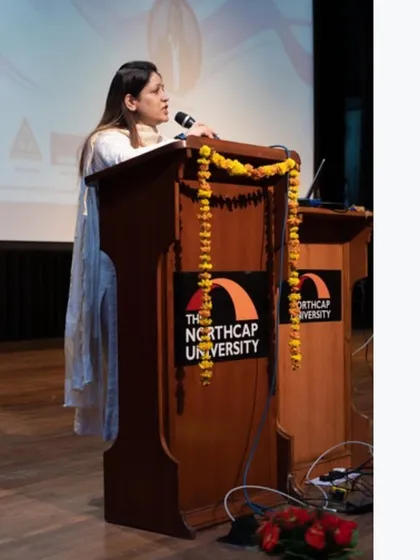 At the podium at The Northcap University, decorated with marigolds, a warm traditional welcome.