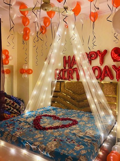 A complete view of the orange and white themed birthday room, ready to surprise the birthday person.