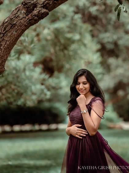 A candid smile from the same mom-to-be. This photo captures a moment of pure joy and happiness, showing the beautiful, unposed side of her personality during the shoot.
