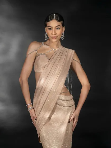 A full-body lookbook image for Nikhil Thampi. This shot presents the complete outfit, showing how the draped saree and intricate jewelry work together to create a cohesive, high-fashion look.