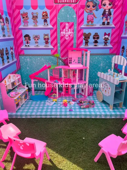 Spark their imagination with our pretend play rentals. This setup includes a Barbie Dream House, a play kitchen, and an ice cream cart, all arranged to create a wonderful world of make-believe for the party guests.