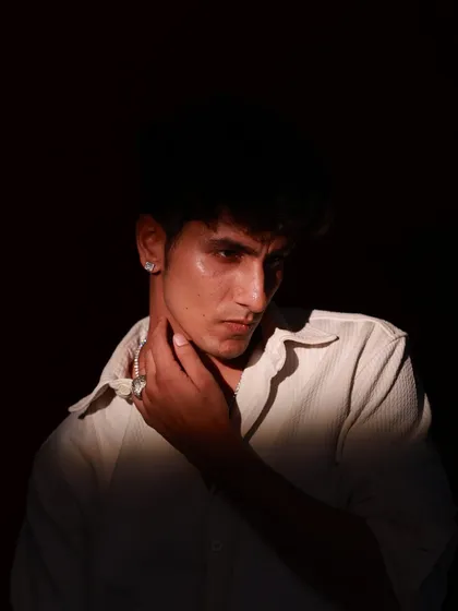 A moody male portrait using a single light source to create dramatic shadows, highlighting the subject's intense gaze and features.