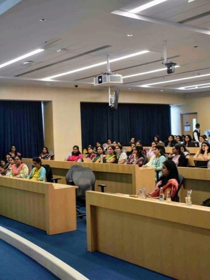 An audience of professionals at a corporate workshop, fully engaged in the session. My goal is to make learning interactive and relevant to their work.