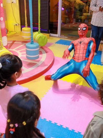 Spider-Man strikes a pose, and the kids watch in amazement. We choreograph these moments to ensure everyone gets a great view of the action.