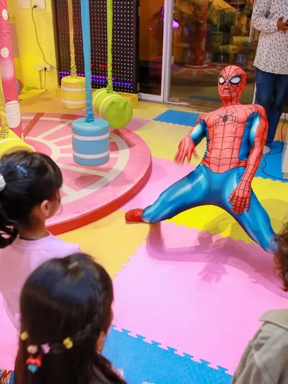 Spider-Man strikes a pose, and the kids watch in amazement. We choreograph these moments to ensure everyone gets a great view of the action.