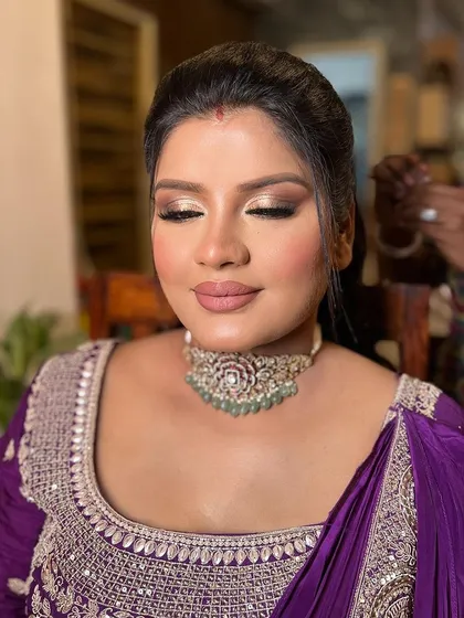 A moment of serenity, showcasing the beautifully blended eye makeup and the flawless skin. The client looks relaxed and confident.