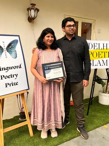 A proud moment for our first prize winner, Surabhi Naik, posing with her husband and her award.
