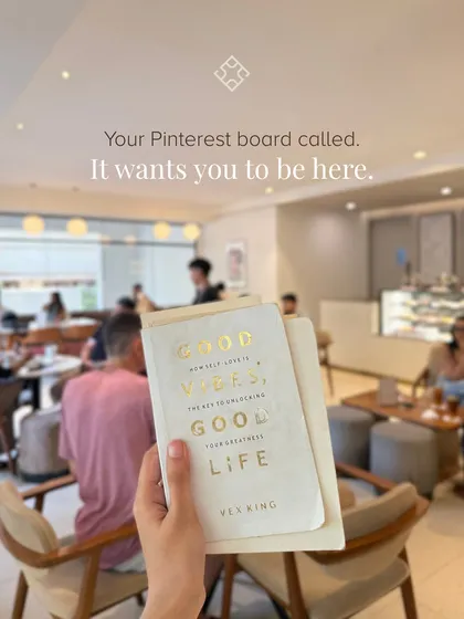 Your Pinterest board called, it wants you to be here. A customer holding a book with our bustling cafe in the background, capturing the perfect "main character" moment.