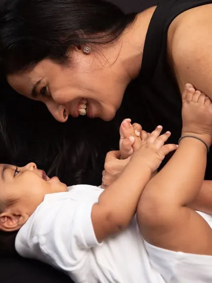 I always pay attention to the hands and eyes in my photographs, as they emote so much. Here, the playful interaction and shared gaze between mother and baby tell a story of love and connection.