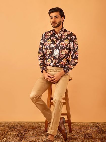 A seated portrait in our bold floral shirt, proving that a statement piece can also be sophisticated and elegant.