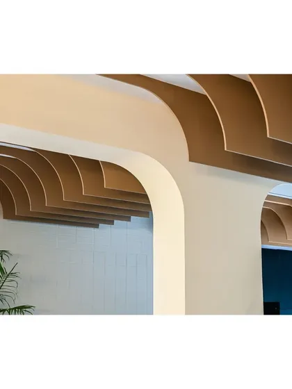 A close-up detail of the layered ceiling fins, which transform a structural challenge into a beautiful, sculptural feature.