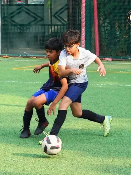 A tense moment on the field as two players challenge for the ball. This image captures the competitive nature of youth football and the determination of our players.