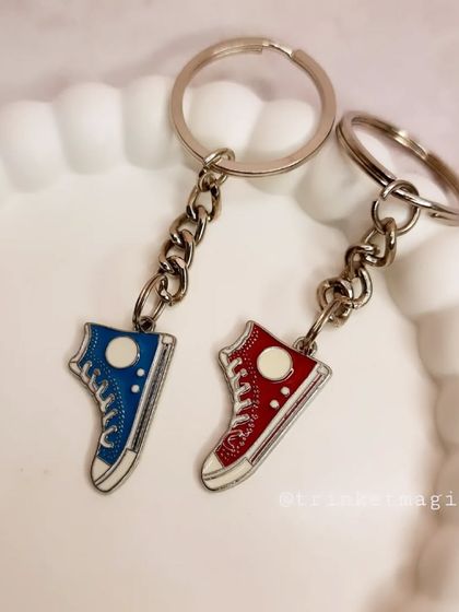 A pair of red and blue sneaker charm keychains, perfect for best friends or a couple who share a love for sneakers.