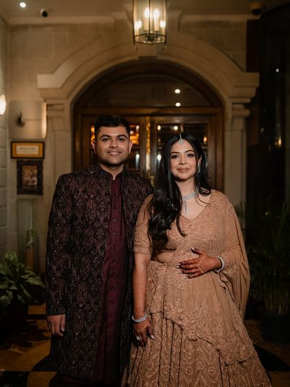 A classic portrait of the couple at their Sangeet, looking elegant and happy.