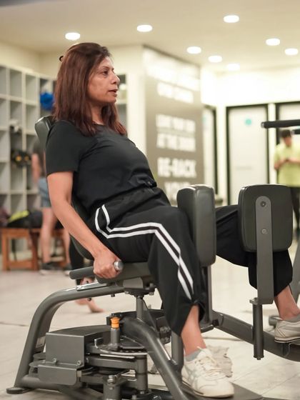 A member uses the hip abduction and adduction machine, which is great for strengthening the inner and outer thigh muscles.