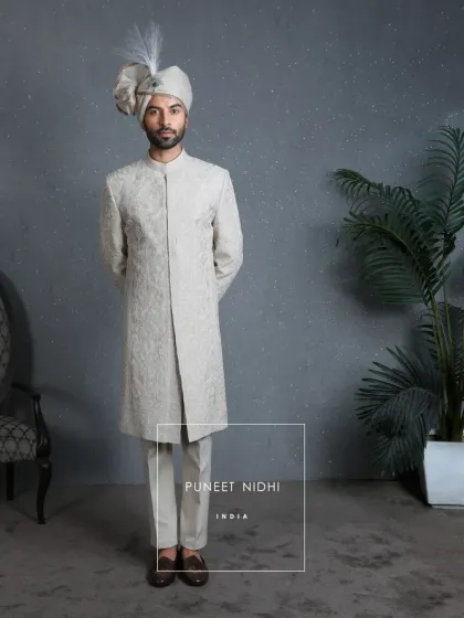 A view of the ivory jacquard sherwani without the stole, highlighting the clean silhouette and the continuous floral and vine pattern. This piece stands as a testament to understated, timeless fashion.