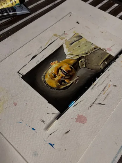 A different view of the childhood portrait, showing the small size and intricate detail of the work.