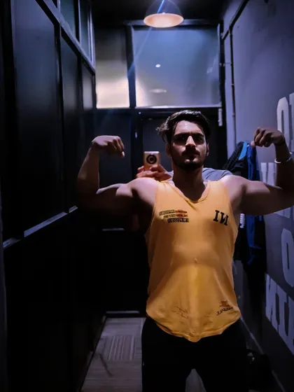 A bicep pose in the changing room after a solid arm workout.