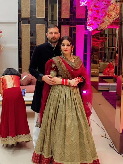 A classic look for a newlywed bride. This elegant lehenga with a traditional red dupatta is perfect for post-wedding functions, blending heritage with timeless style.