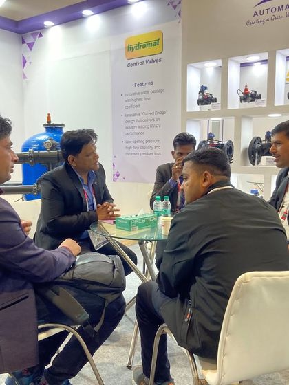 A focused discussion happening at our PlastIndia stall. Our team takes the time to sit down with potential clients to understand their specific filtration and irrigation challenges.
