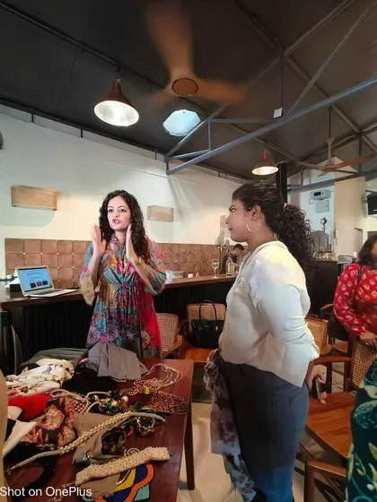 Demonstrating how to evaluate different styles and accessories during the Herkey workshop. Hands-on learning is crucial for building confidence in making new style choices.