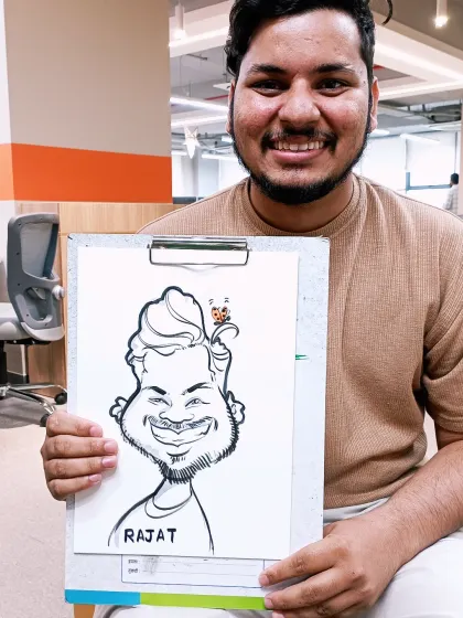 This team member was thrilled with his caricature. It's always great to see people enjoying a bit of creative fun during their workday.