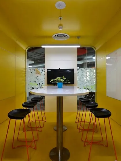 The "yellow box" meeting room. The bright, uniform color on the walls and floor makes the space feel unique and is designed to stimulate creative thinking.
