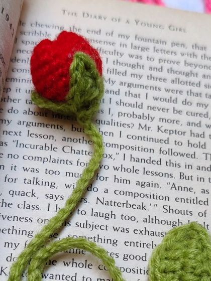 Another shot of the red tulip bookmark inside a book.