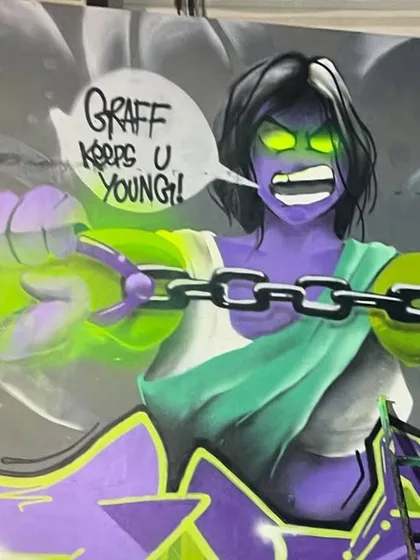 The finished character from the "Attitude Adjustment" mural. The speech bubble says "Graff Keeps U Young!" which is the absolute truth.