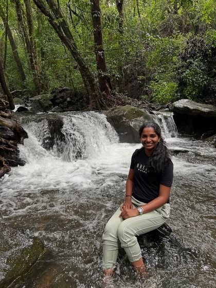A trekker enjoying the cool, clear water of a stream on the way to Netravathi Peak.