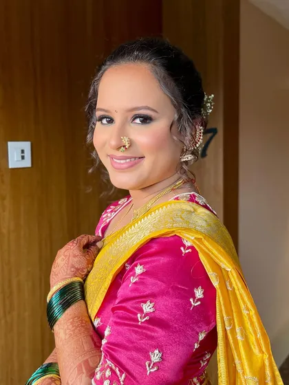A happy portrait of the bride. Her makeup is flawless, with a focus on creating a smooth, glowing canvas that lasts all day.