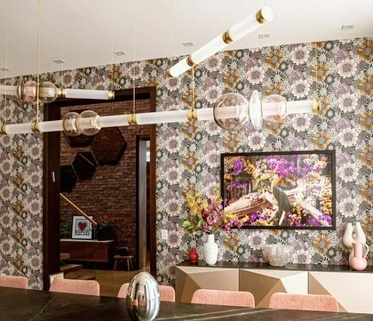 An angled view of the Luna Kaleido installation, showing how its intersecting forms create a dynamic, multi-layered composition. The fixture interacts beautifully with the art and patterns in the room.