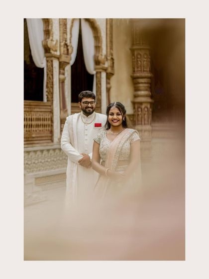 A creatively framed shot of the couple, using foreground blur to create a sense of intimacy and focus.
