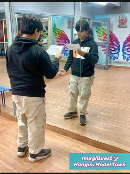 Another student using the mirror effect to prepare for the Shakespeare theatrical. He is seen practicing his script, focusing on his expressions and stage presence in our well-equipped studio.