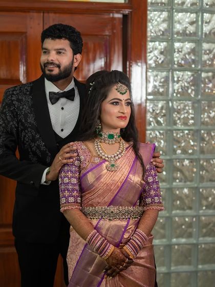 The beautiful couple. Sushma's modern reception look, with her hair in soft waves and glamorous makeup, perfectly complements her husband's classic tuxedo.