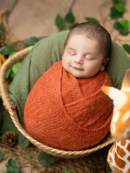 A smiling newborn in our jungle theme setup, complete with a friendly tiger and giraffe. This is a fun and adventurous theme for a baby boy or girl.