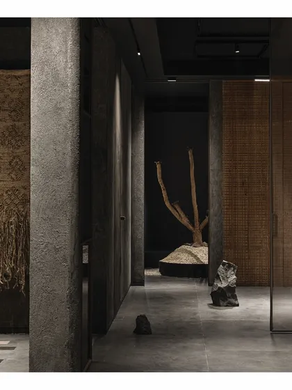 A glimpse into the wandering paths of the 'Frozen' retail store. The design encourages visitors to find and discover, with textured walls, natural elements, and dramatic lighting creating a journey of exploration.