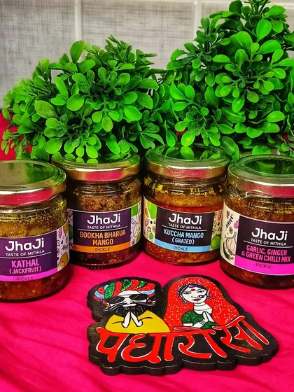 A customer displays their collection of our pickles, including Kathal, Sookha Bharua Mango, Kuccha Mango, and Garlic Ginger Green Chilli Mix.