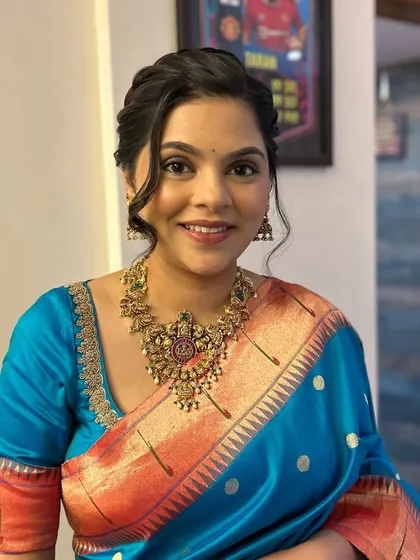 This client looks stunning in her bright blue and orange silk saree. I created a soft glam look that enhances her natural beauty without overpowering the vibrant colors of her attire.