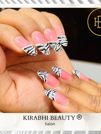 A fun twist on animal print. This design combines a solid pink base with a zebra print French tip, accented with a touch of glitter.
