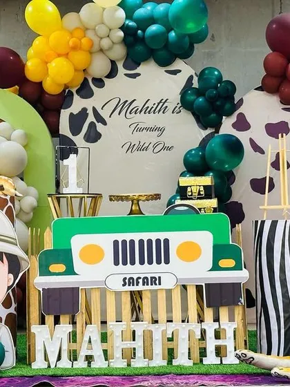 Welcome to the jungle. We had so much fun designing this 'Wild One' safari theme for Mahith's birthday. The setup included a custom backdrop, balloon garlands, and large cutouts of a safari jeep, a friendly explorer, and lots of animals.