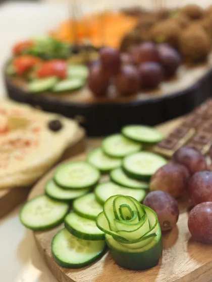 It's all in the details. Here, a cucumber is carved into a delicate rose, adding an artistic touch to a platter of fresh vegetables and dips. This is how I make every food display special.