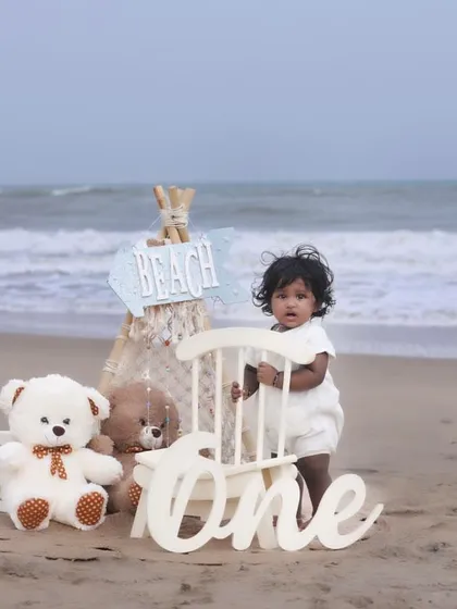 Let's take the celebration outdoors! This first birthday beach photoshoot combines a beautiful natural setting with our curated props for a unique and memorable milestone session. We handle the setup so you can enjoy the moment.