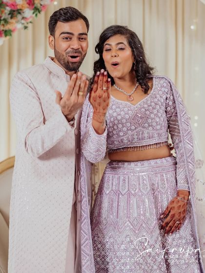 That "we're engaged!" feeling. This shot captures the couple's shared excitement as they admire the ring, a perfect candid moment filled with surprise and joy.