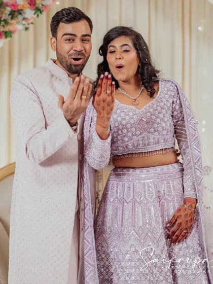That "we're engaged!" feeling. This shot captures the couple's shared excitement as they admire the ring, a perfect candid moment filled with surprise and joy.