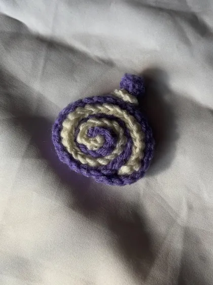 The purple and white swirly cake roll charm. This color combo is super cute and was a custom request.