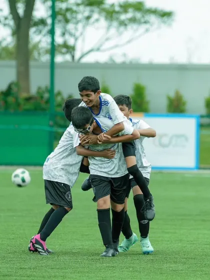 A heartwarming moment of celebration as teammates pile on top of each other after scoring a goal during the DPDL Super Cup. This image perfectly captures the essence of teamwork making the dream work.